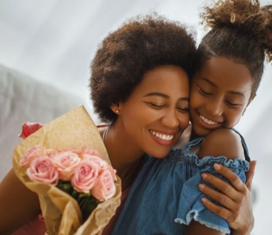 child giving a gift to mom