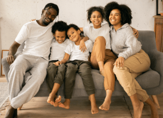 Happy family sitting on couch. Will & estate planning