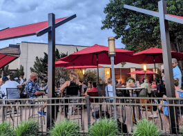 restaurant patio tables with red umbrellas
