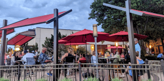 restaurant patio tables with red umbrellas