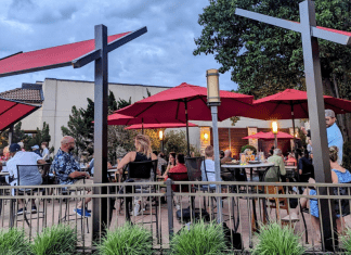 restaurant patio tables with red umbrellas