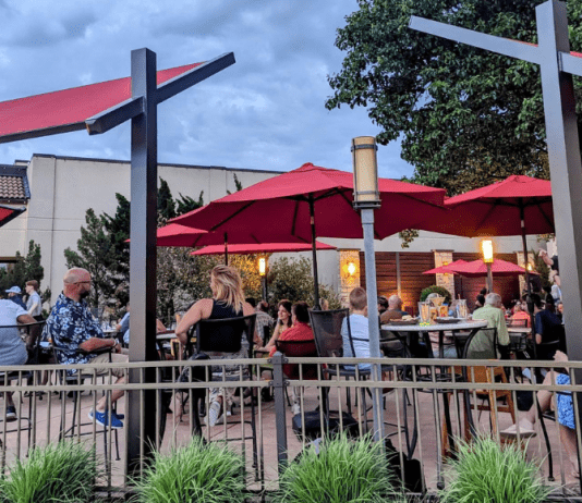 restaurant patio tables with red umbrellas