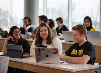 college students ait at a table