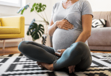 Pregnant woman sitting on the floor
