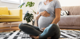 Pregnant woman sitting on the floor