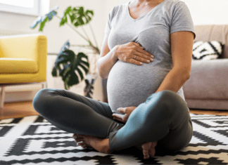 Pregnant woman sitting on the floor